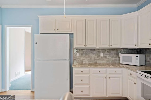 kitchen featuring white cabinetry, light stone counters, white appliances, and ornamental molding