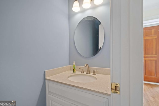 bathroom featuring hardwood / wood-style flooring and vanity