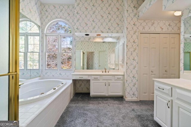 bathroom with vanity and independent shower and bath