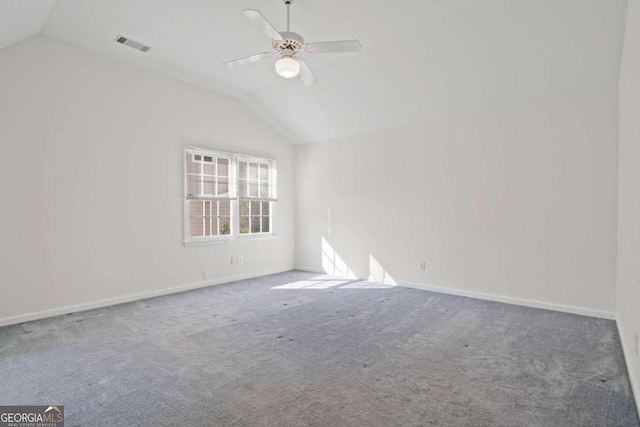 unfurnished room featuring carpet flooring, vaulted ceiling, and ceiling fan