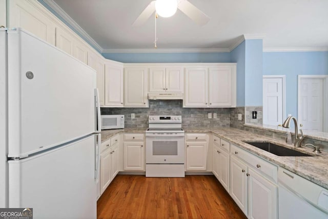 kitchen with white appliances, ceiling fan, sink, hardwood / wood-style flooring, and white cabinetry