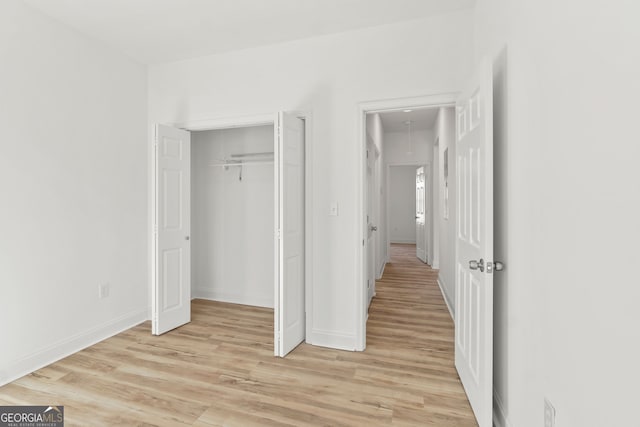 interior space with light wood-type flooring and a closet