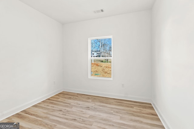 unfurnished room with light hardwood / wood-style floors