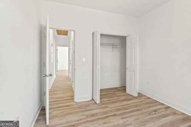 unfurnished bedroom featuring a closet and light hardwood / wood-style flooring