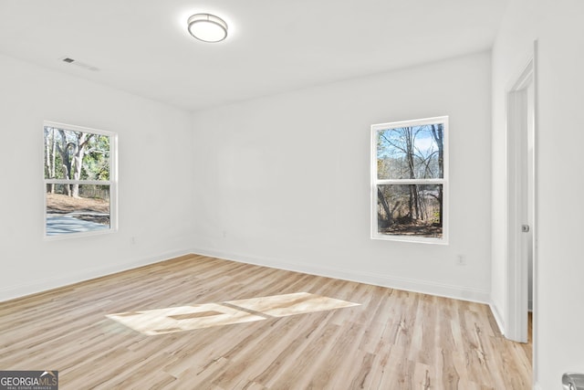 empty room with light hardwood / wood-style flooring