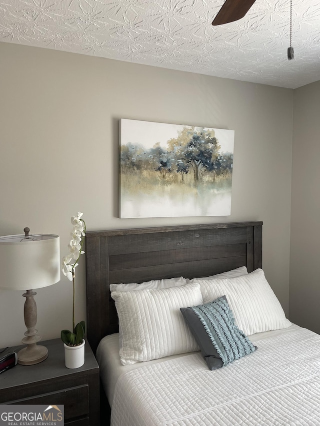 bedroom featuring a textured ceiling and ceiling fan