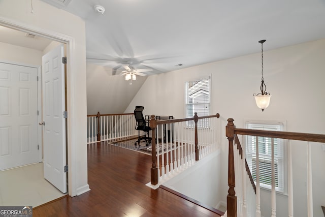 corridor featuring vaulted ceiling and hardwood / wood-style flooring