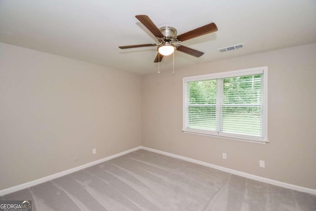 carpeted empty room featuring ceiling fan