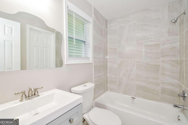 full bathroom with toilet, vanity, and tiled shower / bath