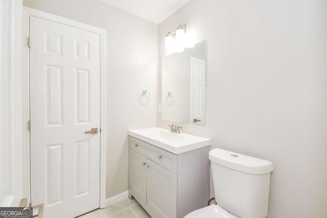 bathroom with tile patterned flooring, vanity, and toilet