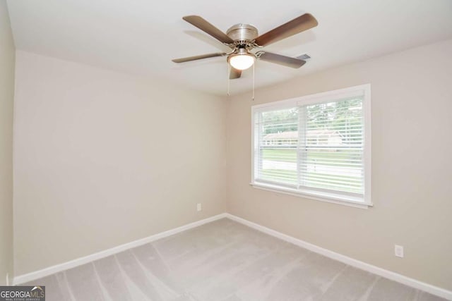 carpeted empty room featuring ceiling fan