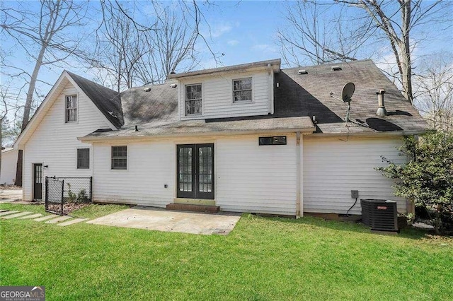 back of property with french doors, a yard, a patio, and central air condition unit