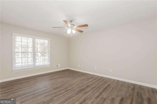 unfurnished room with ceiling fan and dark hardwood / wood-style floors