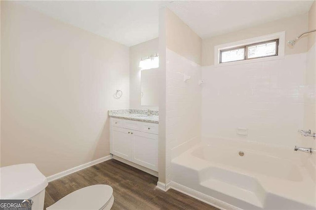 full bathroom featuring vanity,  shower combination, toilet, and wood-type flooring