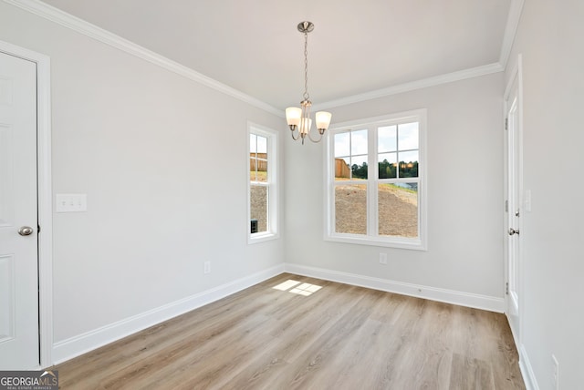 unfurnished dining area featuring an inviting chandelier, light hardwood / wood-style flooring, and ornamental molding