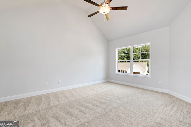 carpeted empty room featuring ceiling fan and high vaulted ceiling