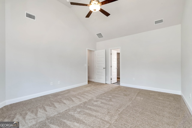 carpeted spare room with high vaulted ceiling and ceiling fan