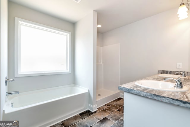 bathroom with vanity and shower with separate bathtub