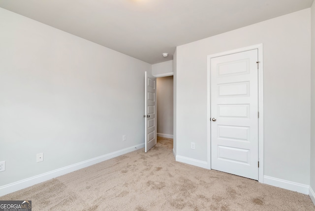 unfurnished bedroom featuring light colored carpet