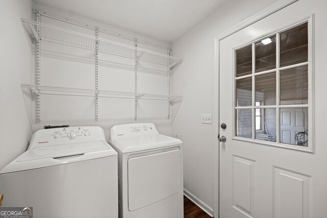 laundry area with independent washer and dryer and dark wood-type flooring