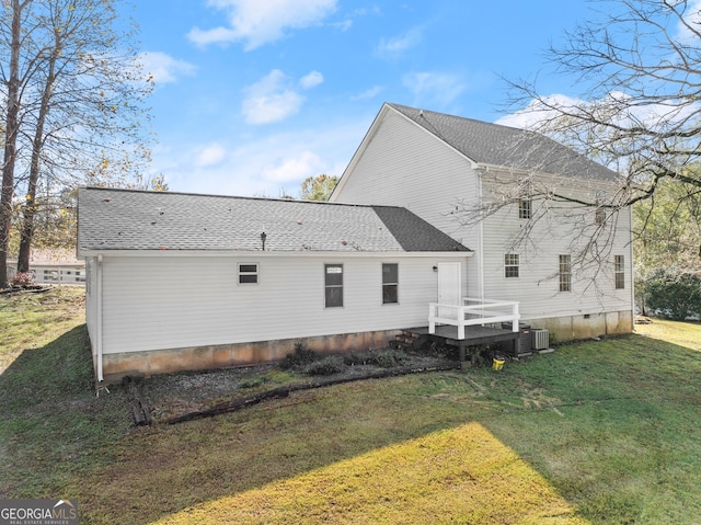 back of property with a lawn and cooling unit