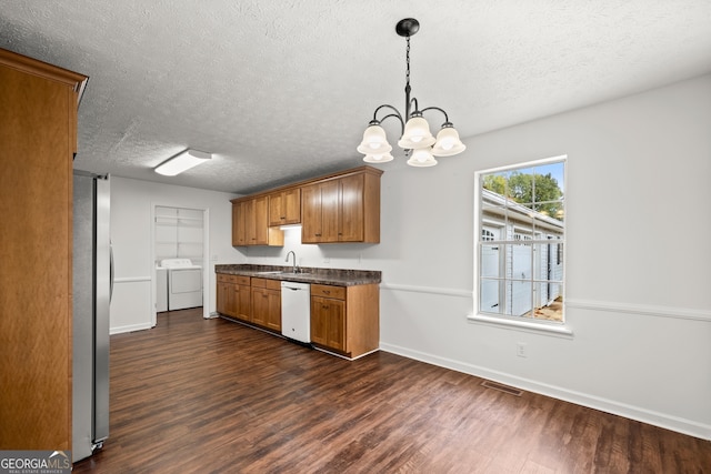 kitchen featuring dark wood-type flooring, white dishwasher, separate washer and dryer, a textured ceiling, and decorative light fixtures