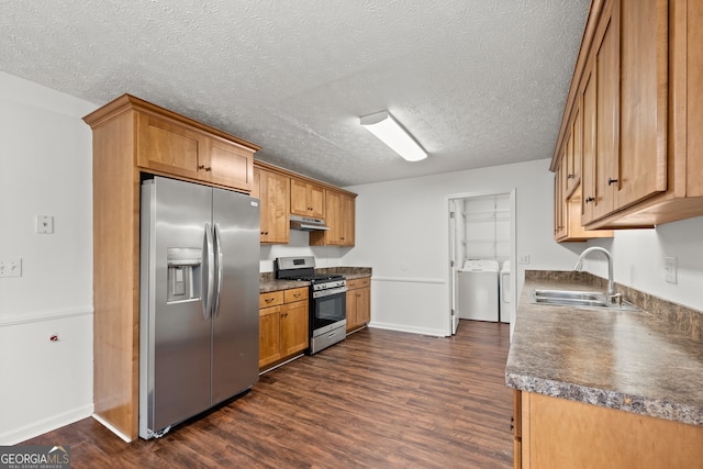 kitchen with sink, separate washer and dryer, dark hardwood / wood-style floors, a textured ceiling, and appliances with stainless steel finishes