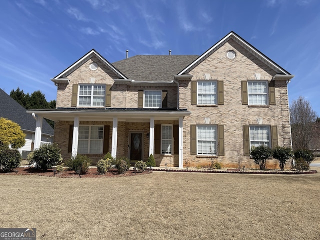 view of front of property with covered porch and brick siding