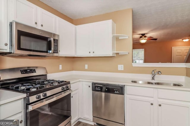 kitchen with white cabinetry, sink, a textured ceiling, and appliances with stainless steel finishes