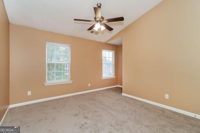 carpeted empty room with ceiling fan and lofted ceiling