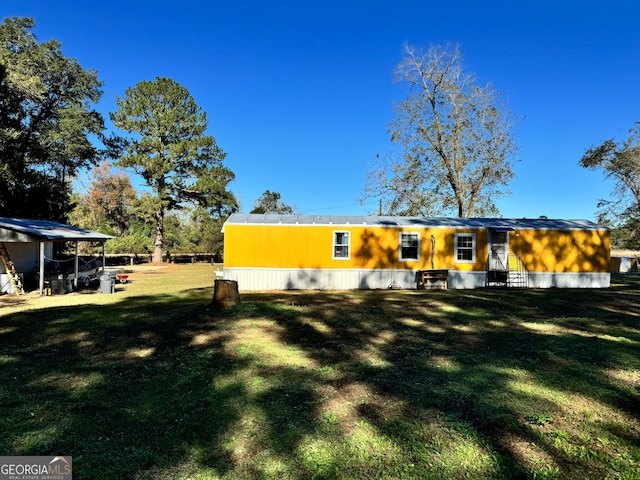 back of property featuring a lawn