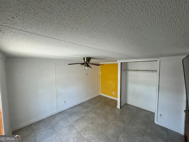 unfurnished bedroom featuring a textured ceiling, a closet, and ceiling fan