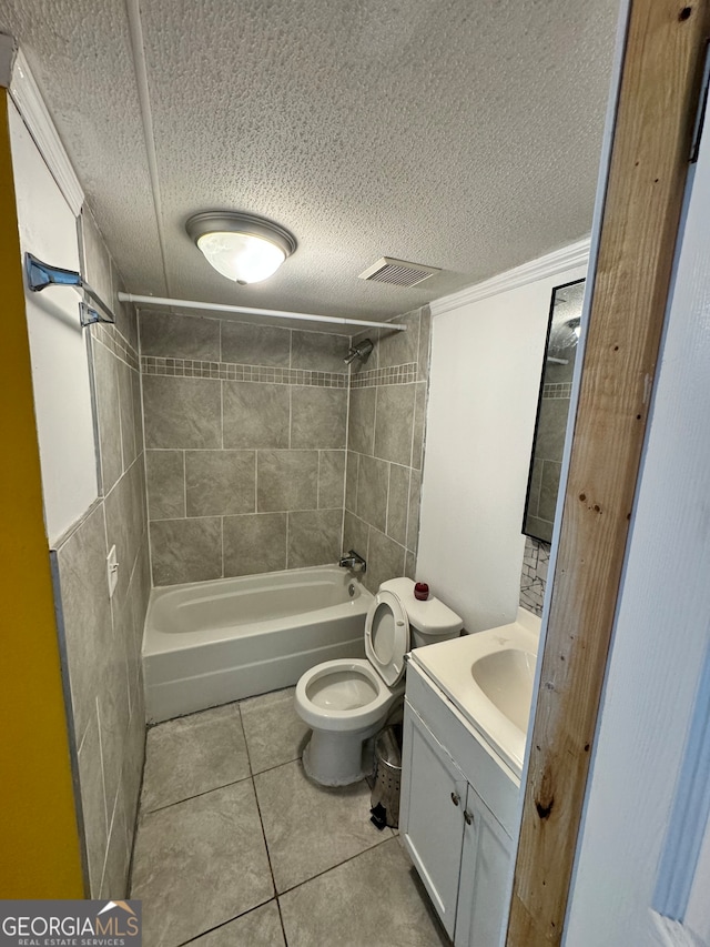 full bathroom with tile patterned floors, tiled shower / bath combo, and a textured ceiling