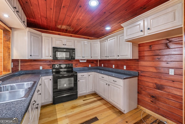 kitchen with sink, wooden ceiling, white cabinets, black appliances, and light wood-type flooring