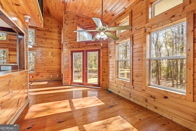 unfurnished sunroom featuring ceiling fan, wooden ceiling, and vaulted ceiling