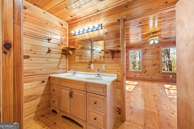 bathroom with vanity, wooden ceiling, wooden walls, hardwood / wood-style flooring, and ceiling fan