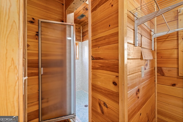 bathroom featuring wooden walls