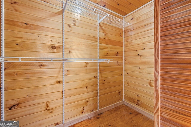 laundry room featuring wood ceiling, wood-type flooring, and wooden walls