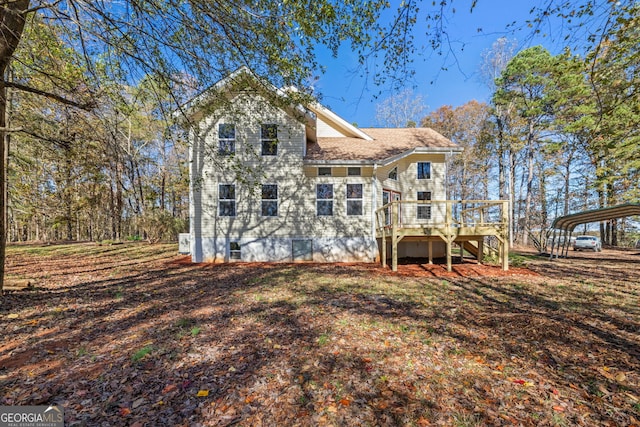 rear view of house with a deck and a carport