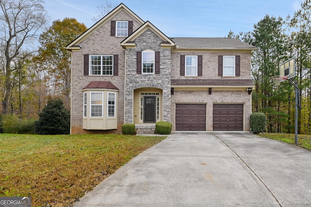 view of front of house featuring a front yard and a garage