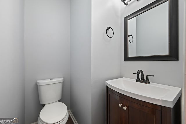 bathroom with toilet and vanity