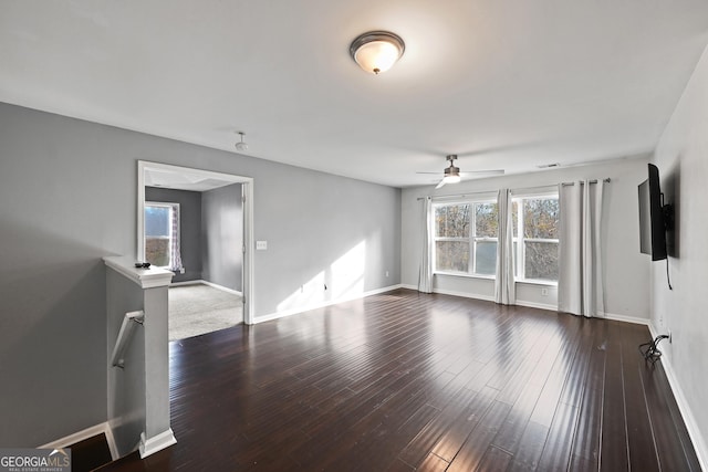 unfurnished living room with ceiling fan and dark hardwood / wood-style floors