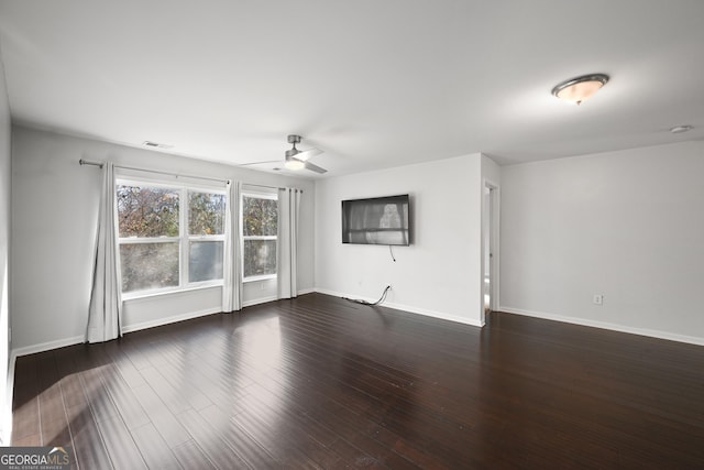 empty room featuring ceiling fan and dark hardwood / wood-style flooring