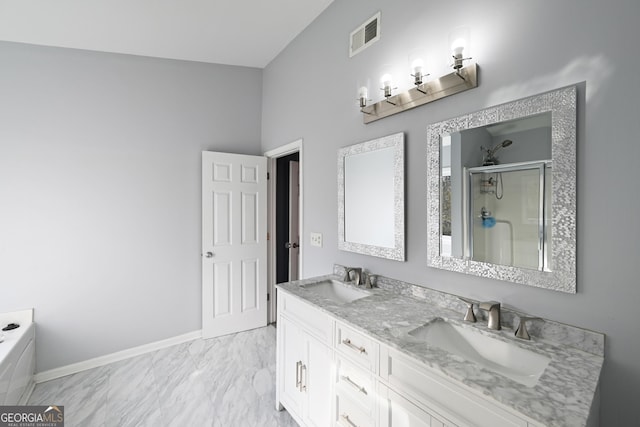 bathroom featuring a shower with shower door and vanity