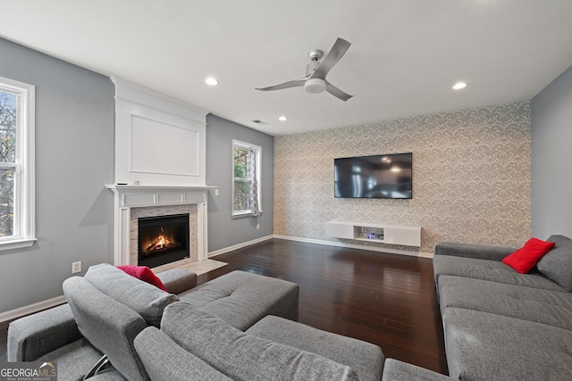 living room featuring ceiling fan and dark wood-type flooring