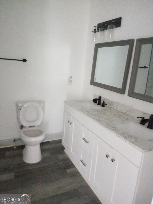 bathroom featuring hardwood / wood-style floors, vanity, and toilet