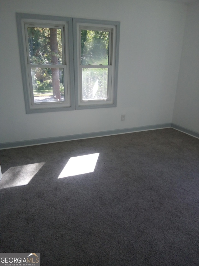 carpeted empty room featuring plenty of natural light