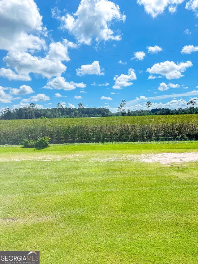 surrounding community with a yard and a rural view