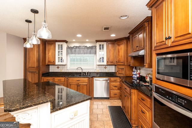 kitchen featuring a center island, sink, appliances with stainless steel finishes, and tasteful backsplash