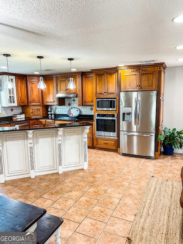 kitchen with hanging light fixtures, stainless steel appliances, backsplash, a textured ceiling, and light tile patterned flooring